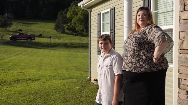 Heather Colley, right, poses with her son, Michah, outside their home Wednesday, Aug. 27, 2025, in Talbott, Tenn. (AP Photo/George Walker IV)