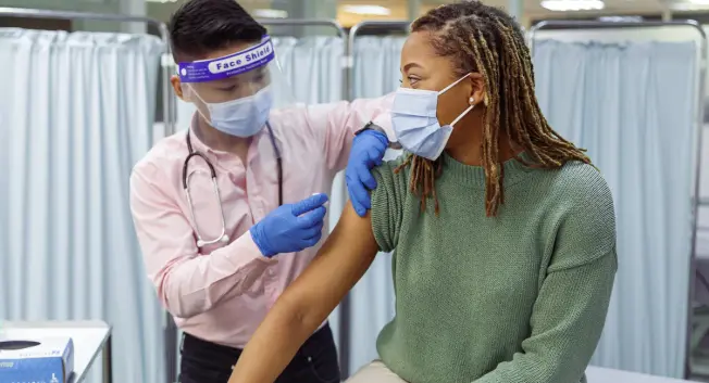 A person receives the COVID-19 vaccine