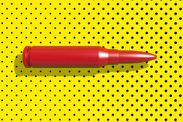 Eine rote Patrone vor einem gelben Hintergrund mit schwarzen Punkten
