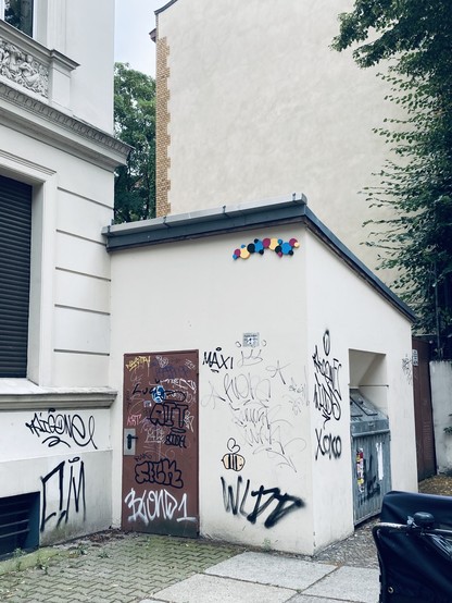 Anbau ein einem alten Mietshaus. Oben Kunst am Bau mit verbundenen Kreisflächen in Cyan, Magenta Yellow und Key.