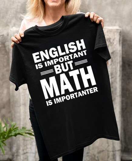 A woman holding up a black T-shirt with the text "English is important, but Math is importanter"