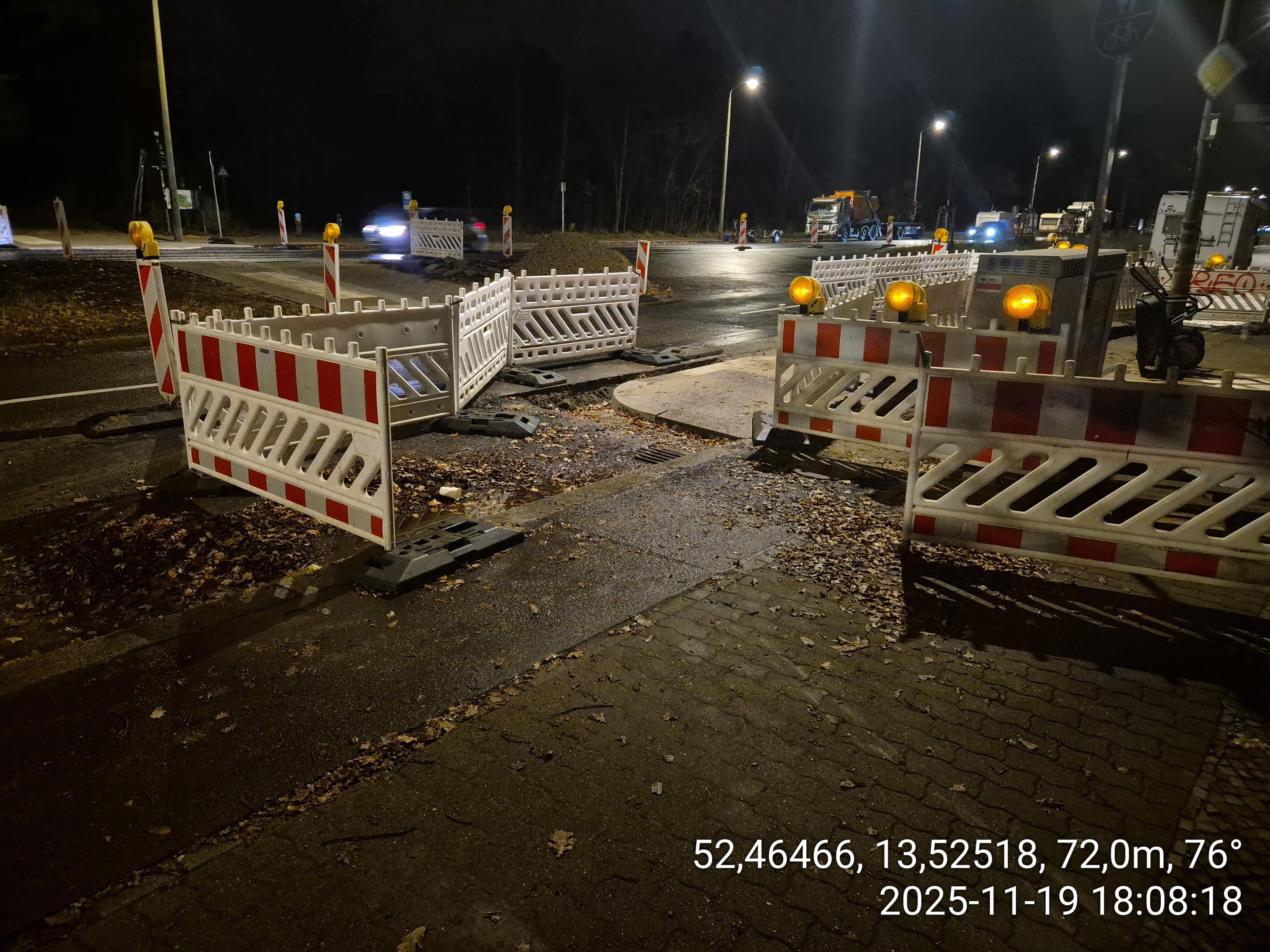 Die Selbe Baustelle wie im vorherigen Foto, hier wird gezeigt, wie Radfahrer und Fußgänger über den Bordstein auf die aufgerissene Fahrbahn und dort über die neu geschaffene Gehwegvorstreckung  (erneuter Bordstein) geleitet werden
